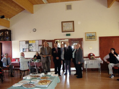 Martin Golding accepts the plaque on behalf of the village